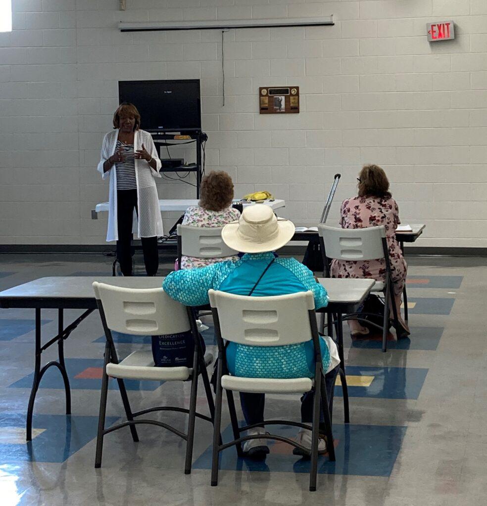 Photo of Leigh Battle talking about Medicare at a recent educational event for seniors.