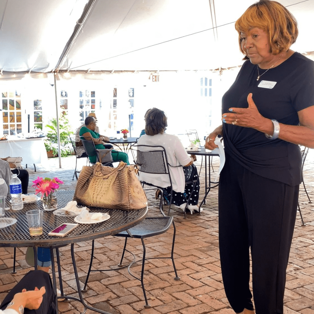 Leigh speaking at client appreciation event under outdoor tent