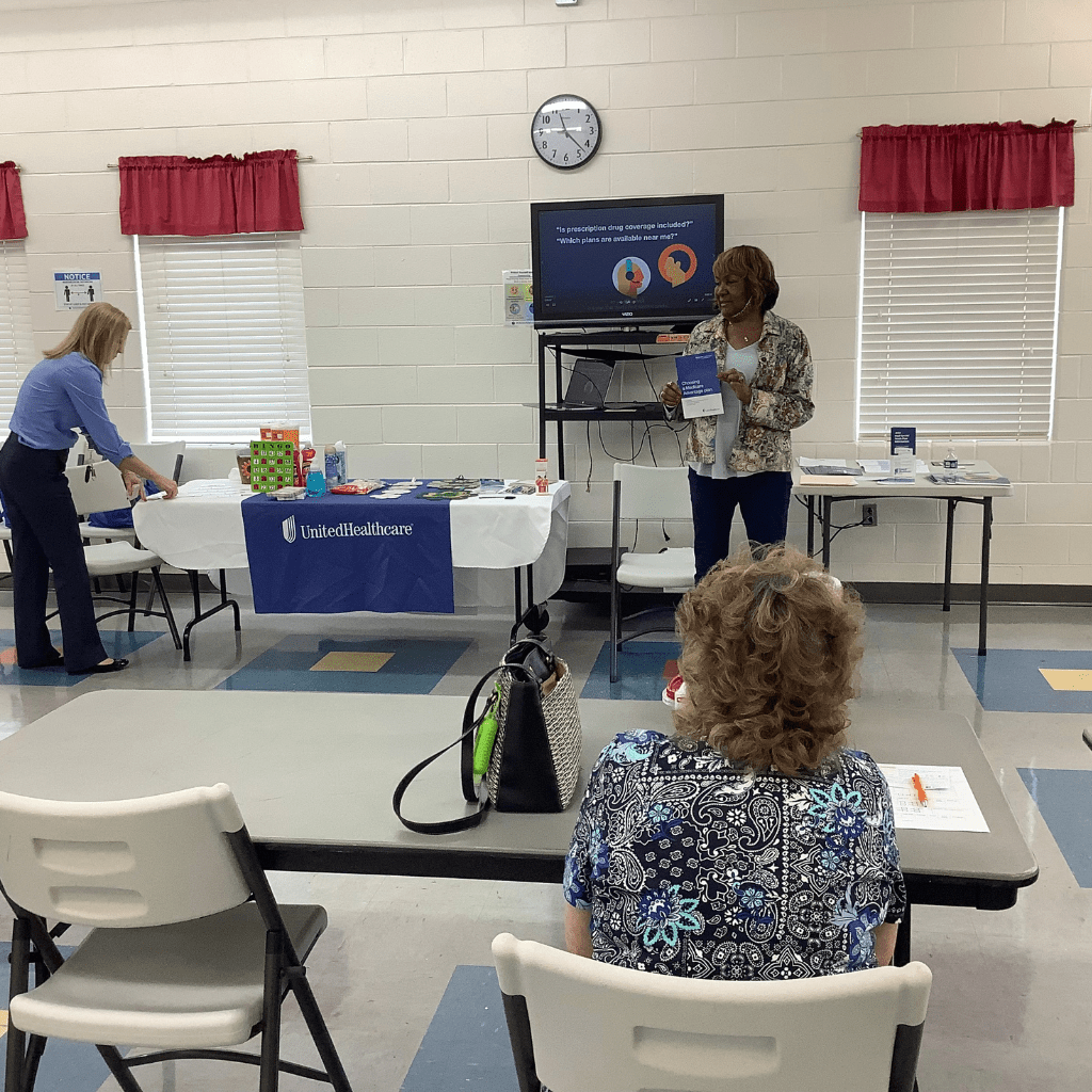 Leigh speaking inside community center teaching Medicare education