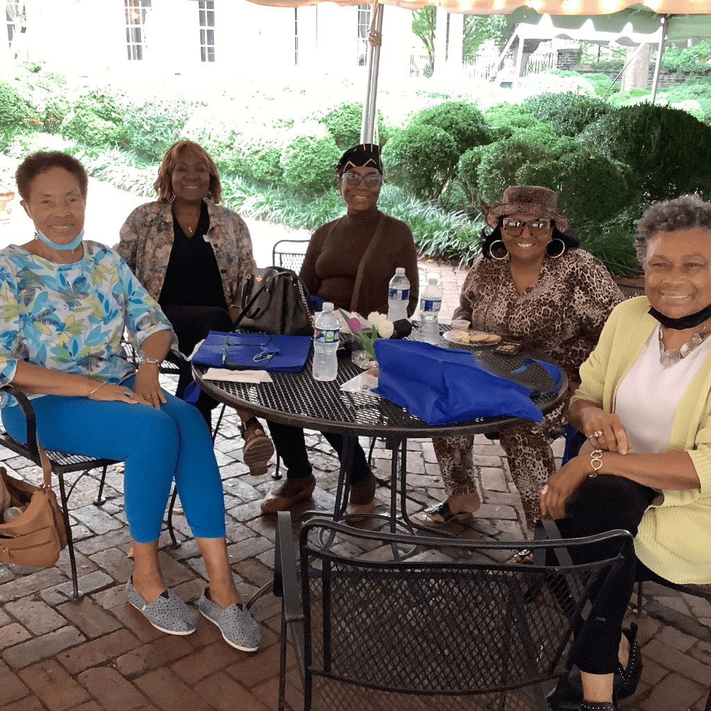 Leigh with event attendees at outdoor patio table