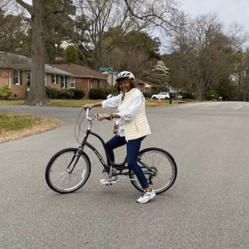 Leigh riding her bike in neighborhood