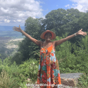 Pretty photo of Leigh with her arms outstretched with the mountains of Southwest Virginia in the background