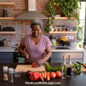 Photo of a Black senior woman in a pretty kitchen chopping up a variety of vegetables with a knife.