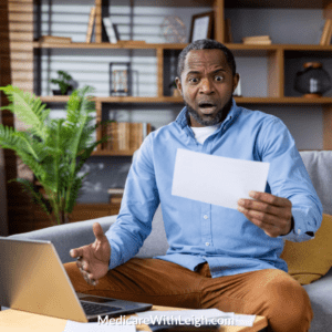 Photo of a senior man sitting in a pretty office with comfortable surroundings looking at a piece of paper and laptop with a confused look on his face